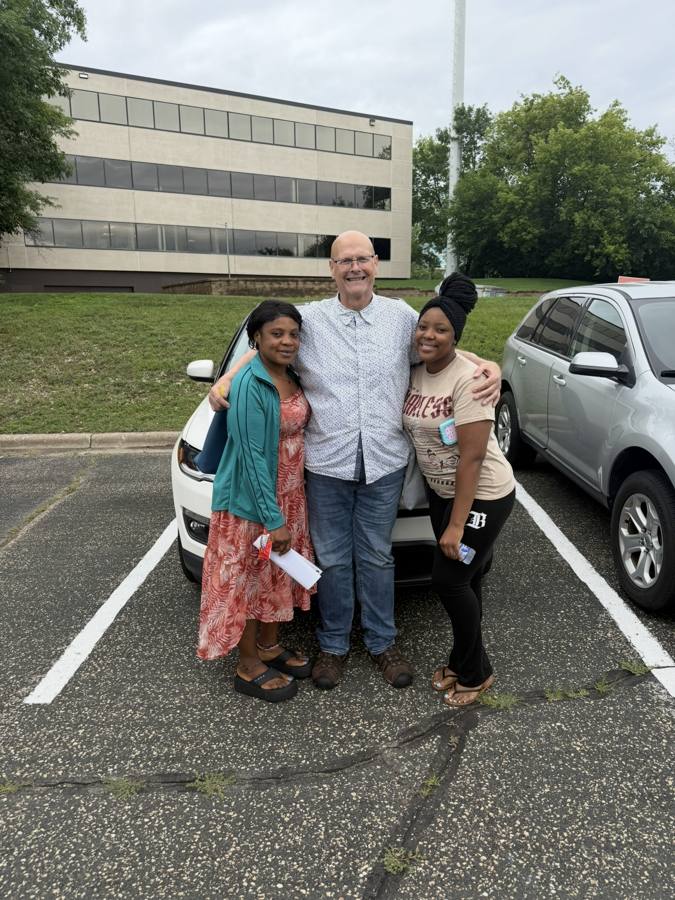 Front Line Auto customers with their new SUV